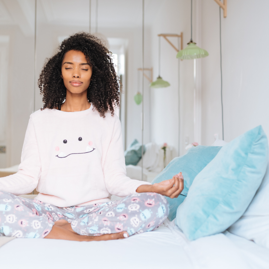 Girl meditating on a bed